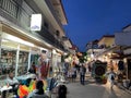 Tourists stroll at night through the streets of Sarti resort located on the Sithonia arm, Halkidiki in Greece
