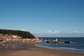 view of scarborough south bay with beach and town on a sunlit summer day with the harbour and castle