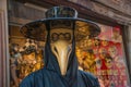 View a scary man in traditional Venetian carnival mask resembling a bird with big beak and wide black round hat, Venice, Royalty Free Stock Photo