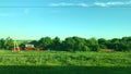 View, scenery from the window of a moving train with green landscape, fields, hills and villages Royalty Free Stock Photo