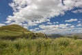 View of scenic green nature and coutryside, hill, grass, flowers in sunny spring