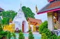 The white gate of Wat Phra That Hariphunchai Temple from its garden, Lamphun, Thailand