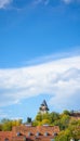 View of the Schlossberg Clock Tower in the distance in Graz against the blue sky Royalty Free Stock Photo