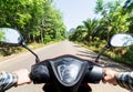 View from the scooter driver seat over the jungle road in Krabi province, Thailand