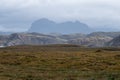 View of the Scottish Highlands near Lochinver, showing Mount Suilven in the background and heather in the foreground.