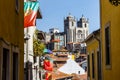 View at the Se cathedral of Porto through a street with Portuguese flags, Portual