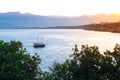 View of the sea bay during sunset. Ship in the sea against the backdrop of mountains. Frigate in the sea at sunset. Boat trip on a Royalty Free Stock Photo