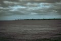 View of a sea with buildings background under a gloomy sky in Borkum