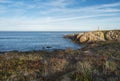 View of the sea and cliffs with the red and white lighthouse at praia pequena beach at wild Vicentina coast in Porto Royalty Free Stock Photo