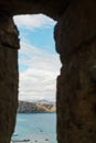 View of the sea coast through the window in the fortress Royalty Free Stock Photo
