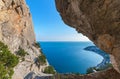 The view of the sea and of the coastline through a big cleft in the rock