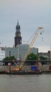 st. Michael\'s church and cranes in the port, Hamburg, Germany Royalty Free Stock Photo