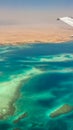 View of the sea and the desert from airplane. Royalty Free Stock Photo