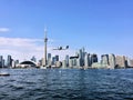 A view of the sea front at Toronto from a boat with a plane coming in to land