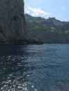 View from the sea of the high impregnable rocks of the mountains on the sea coast. A picturesque sea voyage