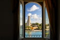 View of the sea, landscaping and Italian Sailors Monument through an arched window in Brindisi Italy Royalty Free Stock Photo
