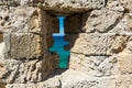 View of the sea through the loophole of the castle wall