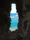 A view of the sea through the loophole of a medieval fort in the southern part of Colliure, France