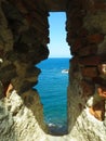 A view of the sea through the loophole of a medieval fort in the southern part of Colliure, France