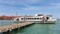 View of the sea pier with a white yacht moored to a wooden bridge Royalty Free Stock Photo