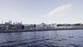 View from the sea side of a beautiful Turkey city with mosque. Action. Summer cityscape and rippling water surface.