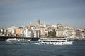 View from the sea to the city of Istanbul, Galata Tower, Golden Horn, boats, hills and seagulls. Calm sea