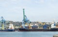 View from the sea to the industrial Harbor of Marseille with cargo cranes, ships and terminals. The largest commercial port in the