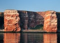 View From The Sea To The Rusty Cliffs Of The North Sea Island Helgoland Shimmering In The Water Royalty Free Stock Photo