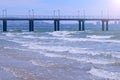 View on sea with waves pier coastal city and mountains at sunny day. Royalty Free Stock Photo