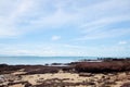 view of sea waves shore and fantastic rocky beach coast on the island and background sky with mountain Royalty Free Stock Photo