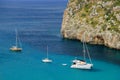 View on on the sea with white boats on the beach Cala en Porter on Menorca