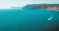 View of the sea with a zodiac boat from the top of a mountain