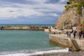 View on seaside, people on the stone pier, Monterosso, Cinque Terre, Italy Royalty Free Stock Photo
