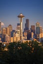 View on Seattle cityscape with Space Needle in front of skyscrapers, during early sunset with sunt hitting the buildings