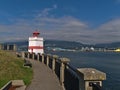 View of Seawall in Stanley Park with white and red painted Brockton Point Lighthouse on sunny day in autumn in Vancouver, Canada. Royalty Free Stock Photo