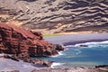 View on secluded lagoon surrounded by impressive rugged weathered cliffs in different colors - El Golfo, Lanzarote