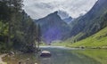 The view of the Seealpsee lake in Appenzell, Switzerland sitting betweeen the tall peaks of the Alpstein mountain range Royalty Free Stock Photo