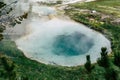 View of Seismograph Pool in Yellowstone National Park, a hot spring pool with teal water