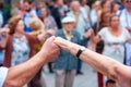 View of senior people holding hands and dancing national dance Sardana