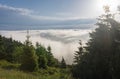 View from  Serak in Jeseniky mountains on a summer foggy morning and  sea of clouds around mountain peak Royalty Free Stock Photo