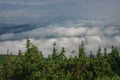 View from  Serak in Jeseniky mountains on a summer foggy morning and  sea of clouds around mountain peak Royalty Free Stock Photo