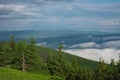 View from  Serak in Jeseniky mountains on a summer foggy morning and  sea of clouds around mountain peak Royalty Free Stock Photo