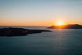 View of the setting sun over the volcano, caldera, Santorini, Greece Royalty Free Stock Photo