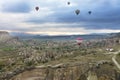 Several balloons fly over the valleys in Cappadocia Royalty Free Stock Photo