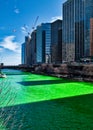 View of shadows of buildings cast along the Chicago River which is dyed green for St. Patrick`s day