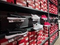 A view of the shelves of a shoe store with a sale of sneakers. Shoes stand on the background of boxes. Editorial photo