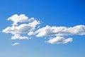 WHITE CLOUDS DRIFTING THROUGH A BLUE SKY Royalty Free Stock Photo