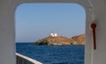 View from ship`s door of lighthouse and agios Nikolaos church. Kea,Tzia island, Greece. Sky background.