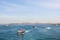 View of the ships going through the Bosphorus from the Galata Bridge, skyline of the Asian side of the city of Istanbul Royalty Free Stock Photo