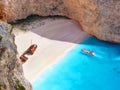 View on Shipwreck beach in amazing bay, boat and ship with swimming people in Ionian Sea blue water Blue Caves. Greece islands Zak